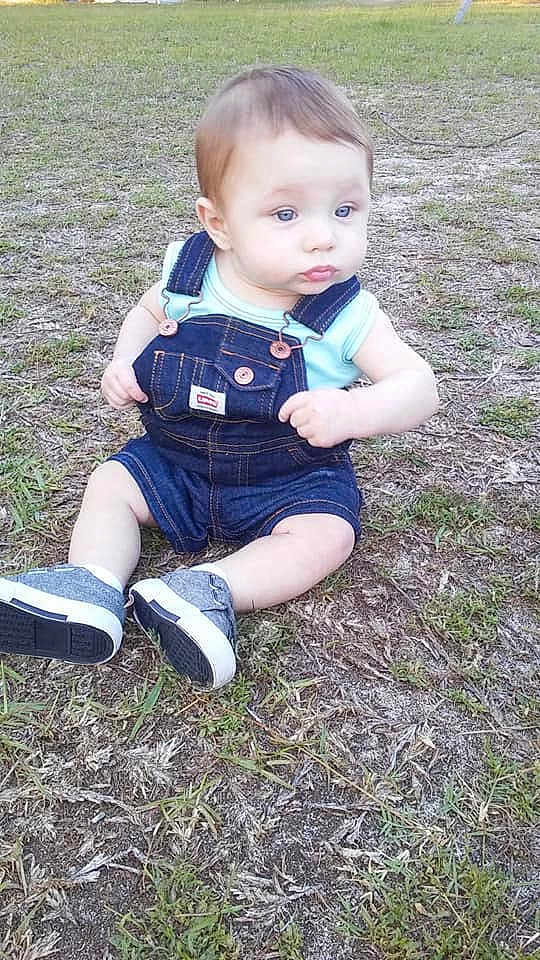 Carroll Johnson Jr is registered to the contest to win money with this photo: baby, blond, child, grass, lawn, leg, person, plant, sitting, skin, smile, toddler