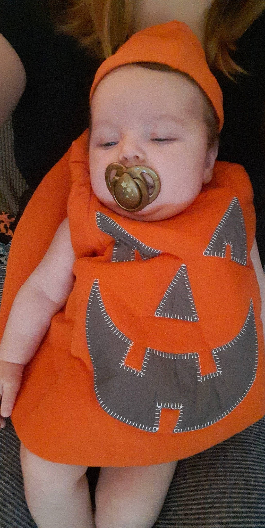 Lilith joined the competition — help win amazing prizes! baby, baby_toddler_clothing, bib, cheek, child, chin, eyelash, face, facial_expression, head, headgear, lip, mouth, nose, orange, outerwear, person, skin, sleeve, toddler