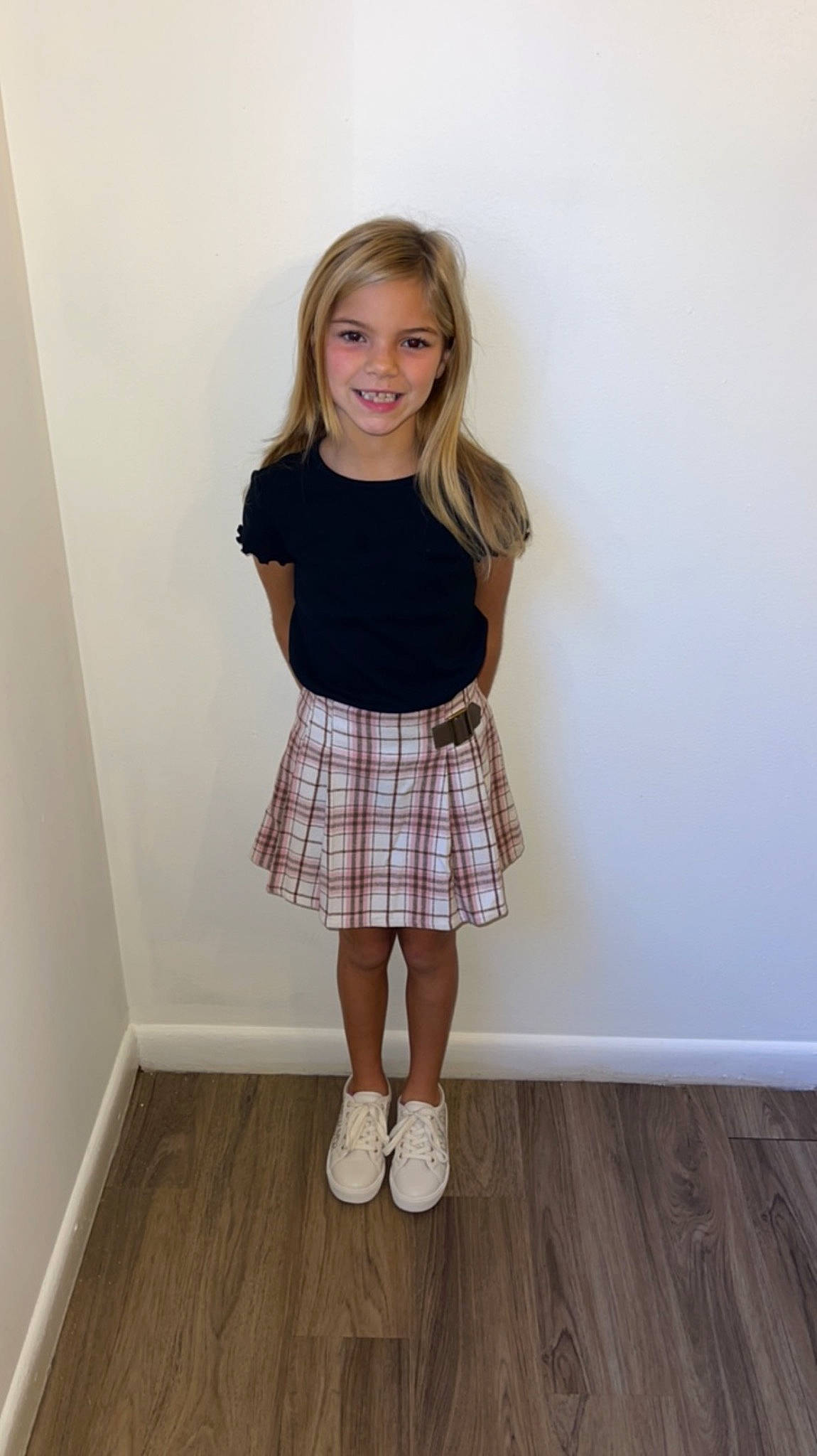 Mia is registered to the contest to win money with this photo: clothing, face, fashion_design, flooring, hair, joy, knee, leg, long_hair, pattern, person, plaid, shoe, shorts, sleeve, smile, sock, t_shirt, tartan, thigh