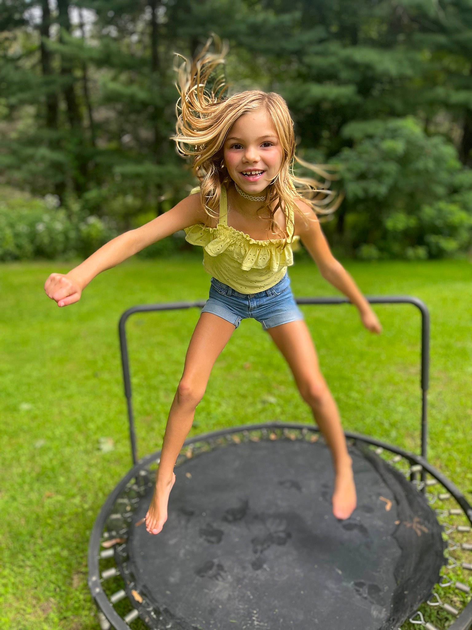 Mia is registered to the contest to win money with this photo: arm, automotive_tire, flash_photography, grass, green, hair, happy, human_body, joy, leg, leisure, light, people_in_nature, person, photograph, plant, recreation, shorts, smile, summer