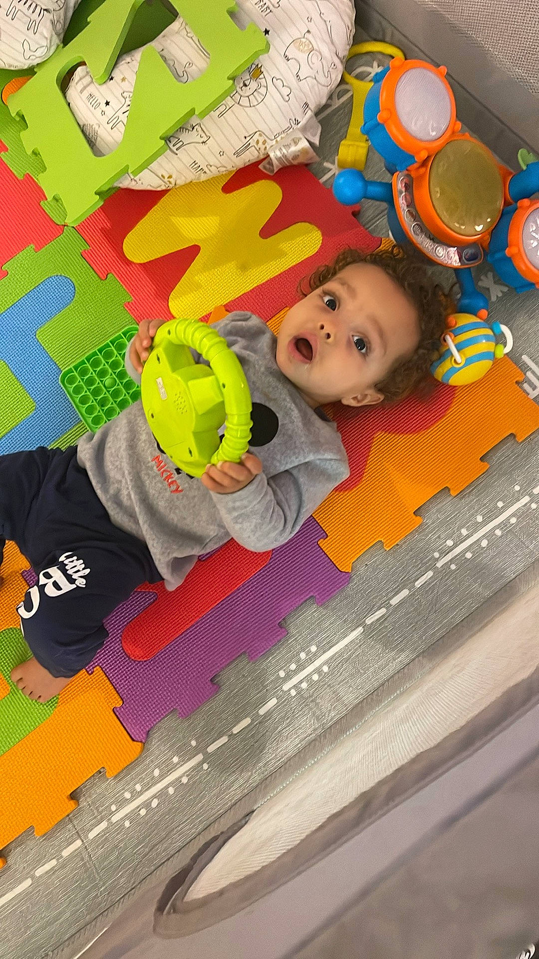 Spencer is registered to the contest to win money with this photo: art, baby, baby_toddler_clothing, baby_toys, child, floor, flooring, fun, happy, leisure, linens, pattern, person, play, room, surprise, toddler, visual_arts, wood