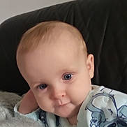 Faith joined the competition — help win amazing prizes! baby, infant, child, blue_eyes, light_hair, cute, cozy, indoor, couch, soft_texture, cartoon_print, clothing, face, portrait, relaxed, young, person, sitting, expression, closeup