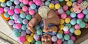Lucia joined the competition — help win amazing prizes! baby, child, ball_pit, colorful_balls, pastel_colors, diaper, smiling, happy, playing, legs, feet, toy, soft_toys, mesh_sides, indoor, playpen, cute, infant, joyful, relaxed