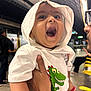 Vihaan joined the competition — help win amazing prizes! baby, child, hoodie, white_clothing, dinosaur_print, earrings, laughing, happy, indoor, subway_station, adult_hand, person, glasses, smiling, cute, portrait, joyful, holding, people, urban