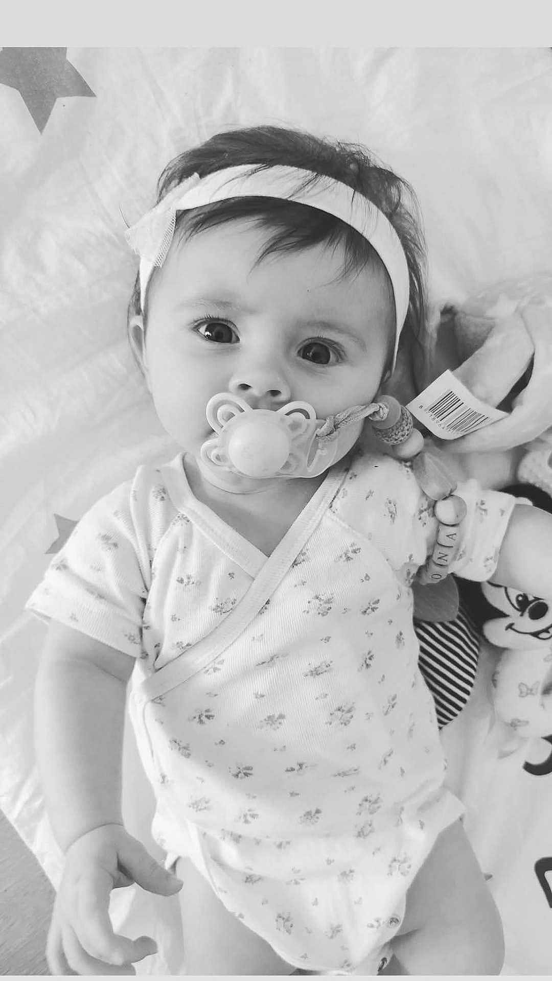Leona-Neela a rejoint le concours — aidez-le/la à gagner de superbes lots ! baby, baby_accessory, black_and_white, child, clothing, cute, expression, face, hand, headband, indoor, infant, lying_down, newborn, onesie, pacifier, plush_toy, portrait, sleepwear, soft_blanket