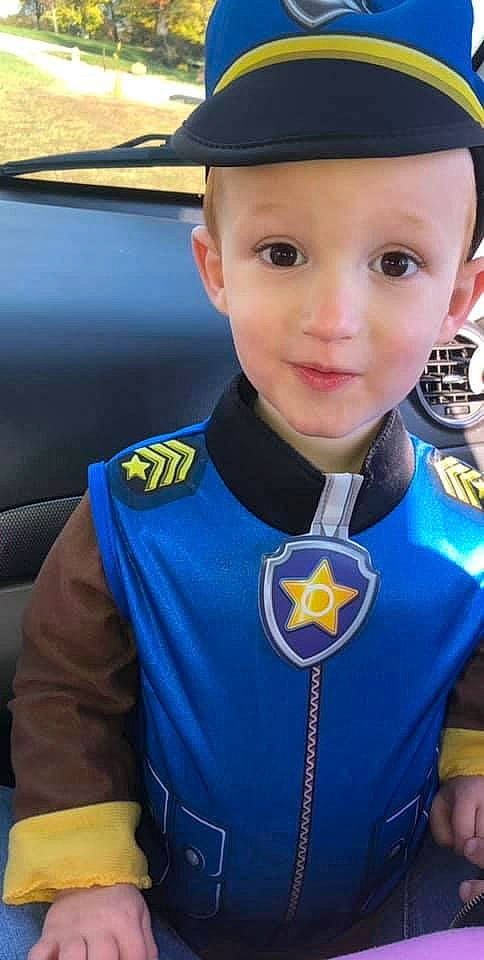 Easton is registered to the contest to win money with this photo: auto_part, automotive_exterior, cap, costume, electric_blue, family_car, fictional_character, fun, headwear, jersey, joy, logo, motor_vehicle, official, person, personal_protective_equipment, sleeve, smile, sportswear, t_shirt