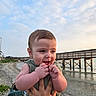 baby, beach, child, clouds, cute, hand, happy, holding, infant, nature, outdoor, person, pier, portrait, shore, sky, smiling, summer, water, wood