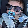 accessory, baby, black, blue, car_seat, child, closeup, clothing, comfort, cute, face, head, infant, pacifier, reflection, seatbelt, soft, star_pattern, strap, sunglasses