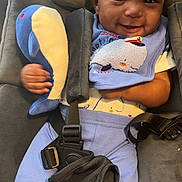 Ramari Roberson joined the competition — help win amazing prizes! baby, child, smiling, car_seat, plush_toy, whale, blue_clothing, bib, infant, seatbelt, cute, happy, portrait, indoors, soft_toy, fabric, person, clothing, baby_toys, seat