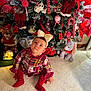 Alba participe au concours pour gagner de l'argent avec cette photo : toddler, child, christmas_tree, holiday_decorations, plush_toy, candy_cane, red_clothing, bow, carpet, ornament, festive, indoor, cute, holiday, sitting, curious, toy, decoration, smiling, family