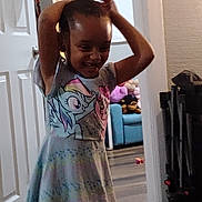 Bella is registered to the contest to win money with this photo: child, girl, smiling, dress, indoor, my_little_pony, toy, couch, stuffed_animal, floor, door, room, happy, person, hair, playful, colorful, furniture, expression, casual