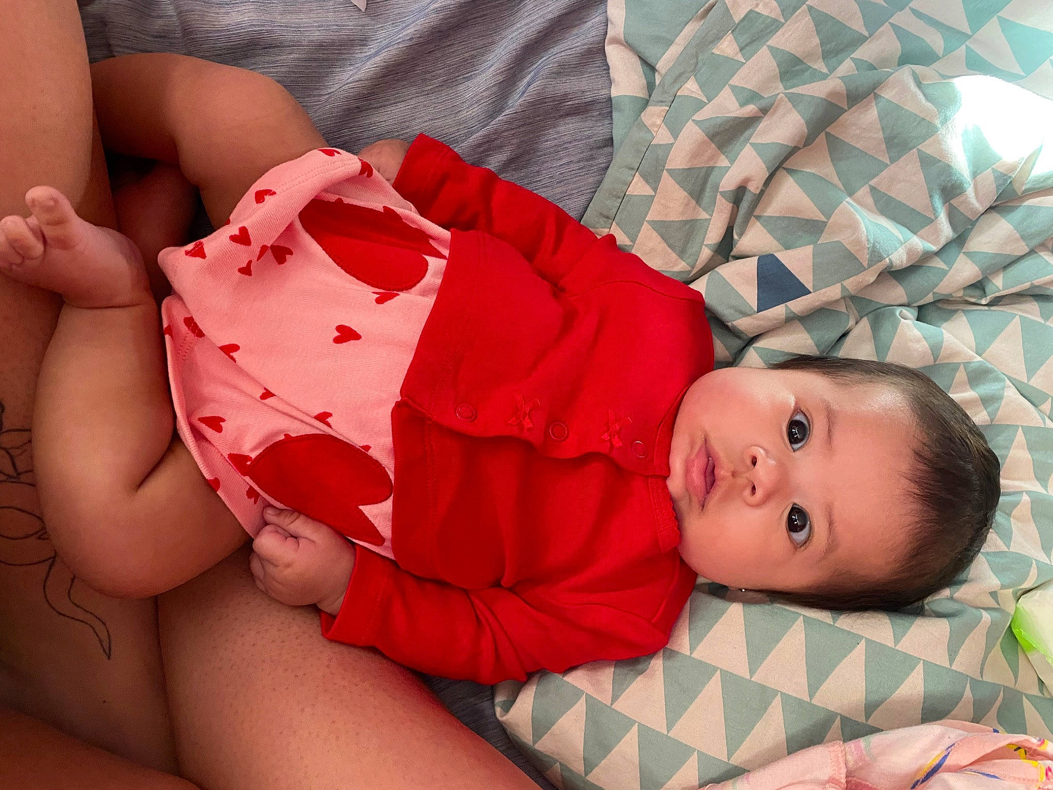 Esther is registered to the contest to win money with this photo: baby, baby_toddler_clothing, cheek, child, comfort, eye, finger, head, human_body, joint, leg, lip, mouth, person, pink, product, skin, stomach, textile, thigh