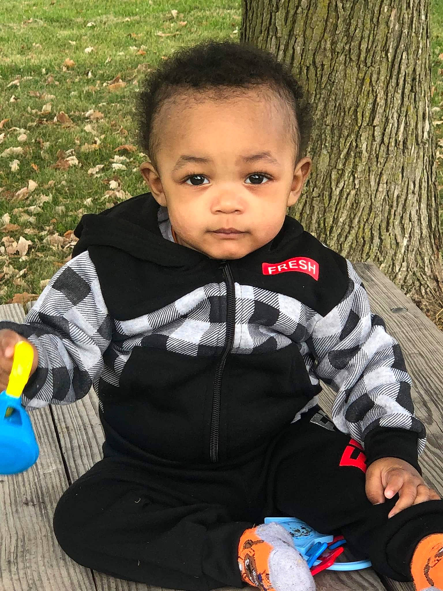 Leondre is registered to the contest to win money with this photo: baby, baby_toddler_clothing, beauty, cheek, child, clothing, dress, face, facial_expression, grass, happy, head, people_in_nature, person, plant, skin, sleeve, standing, toddler, tree