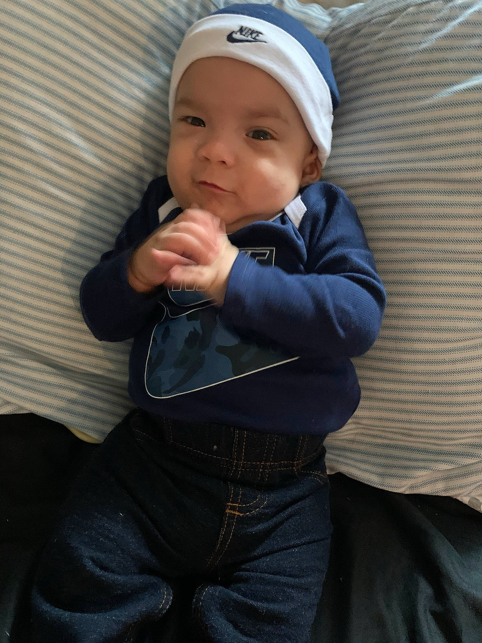 Yeikiel is registered to the contest to win money with this photo: baby, baby_products, baby_toddler_clothing, cap, cheek, child, comfort, eye, fashion_accessory, gesture, hand, happy, head, headgear, headwear, person, sitting, skin, sleeve, smile