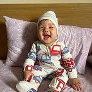 Alexander joined the competition — help win amazing prizes! baby, child, smiling, pajamas, hat, bed, pillow, wooden_headboard, indoor, person, happy, sitting, cute, infant, cozy, blanket, sleepwear, expression, portrait, young