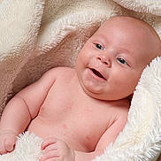 Freddie joined the competition — help win amazing prizes! baby, infant, smile, blanket, soft, cozy, skin, cute, child, happy, face, newborn, portrait, flesh, hands, young, warm, comfort, expression, lying_down