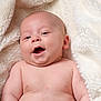 baby, infant, smiling, face, skin, blanket, soft_texture, happy, cute, child, closeup, portrait, naked_torso, newborn, lying_down, indoors, cozy, warm, expression, head