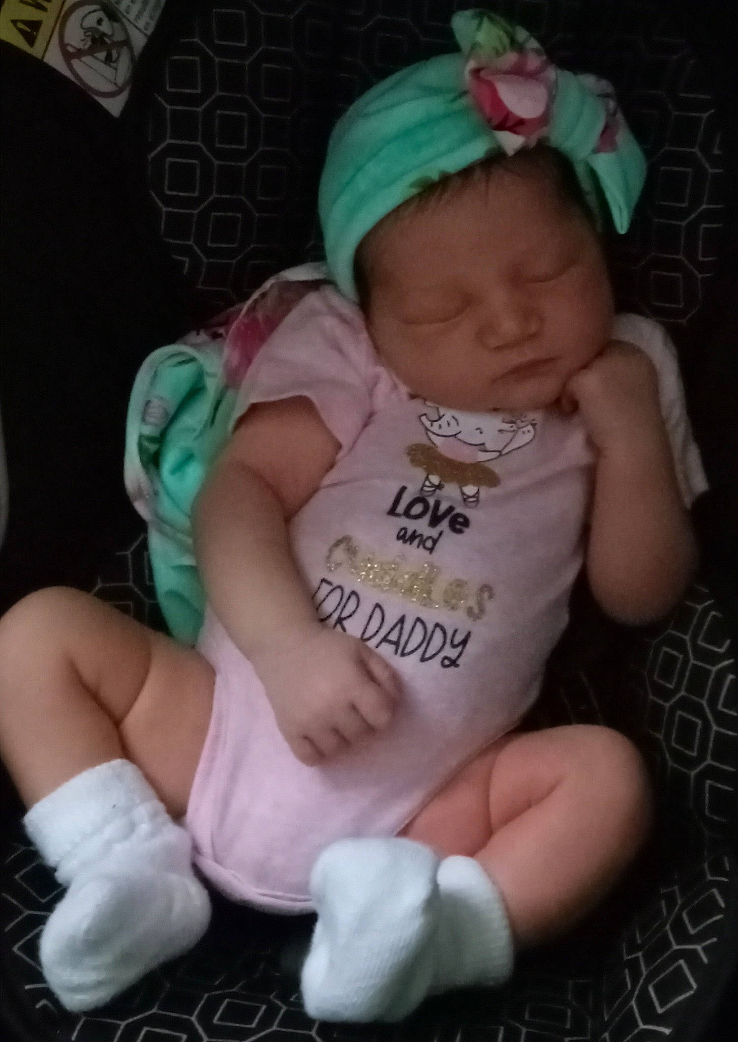 Siya is registered to the contest to win money with this photo: baby, baby_products, baby_toddler_clothing, cheek, child, fashion_accessory, finger, hat, headband, headgear, iris, lap, nail, pattern, person, pink, sitting, sock, thigh, thumb