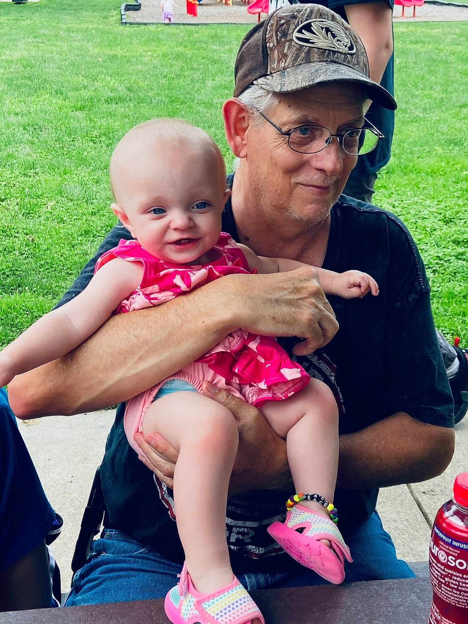 Alaina joined the competition — help win amazing prizes! baby, baby_toddler_clothing, event, friendship, fun, grass, happy, headwear, interaction, joy, lap, leisure, person, pink, plastic_bottle, recreation, red, shorts, skin, summer