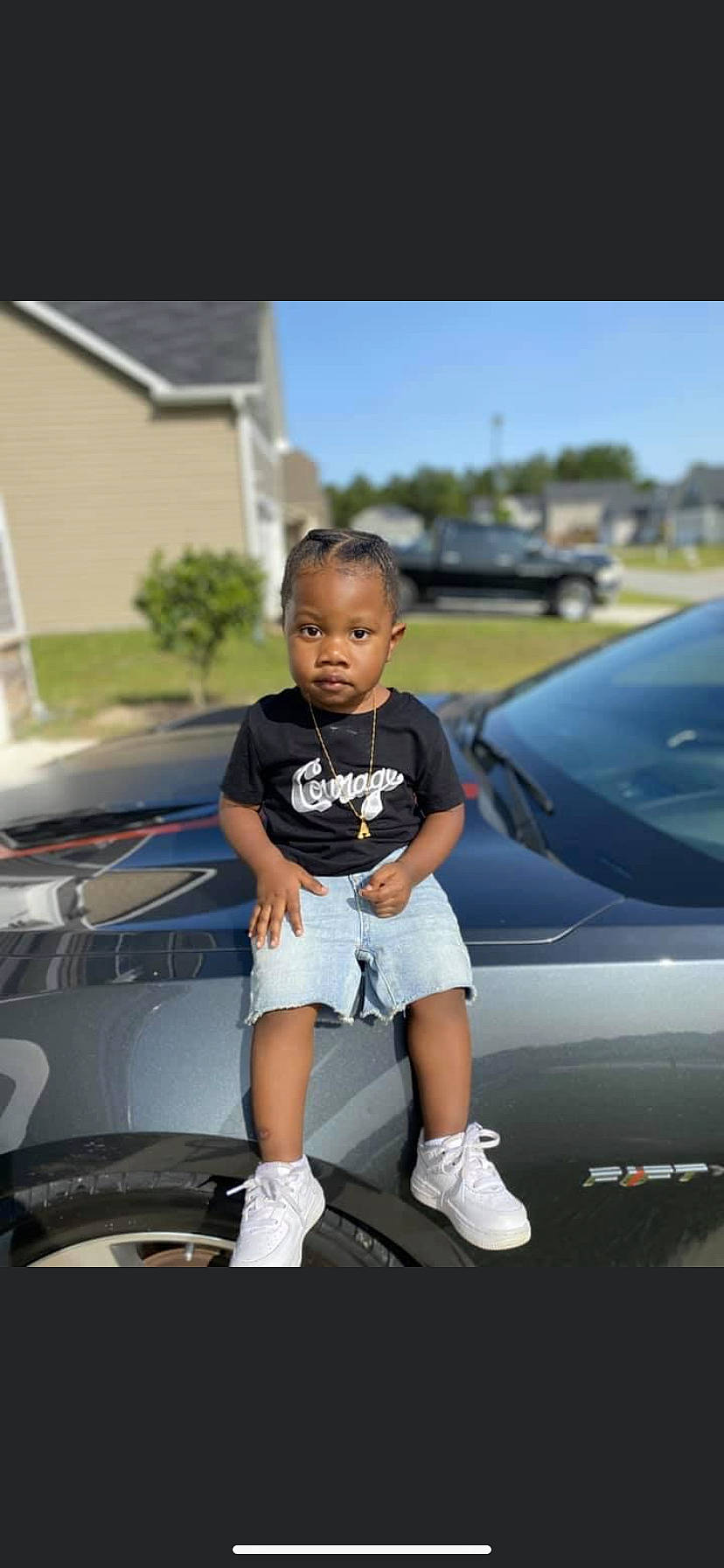 Ashton is registered to the contest to win money with this photo: automotive_design, automotive_exterior, automotive_lighting, automotive_tire, automotive_wheel_system, bumper, car, hood, motor_vehicle, person, shoe, shorts, shoulder, sky, sneakers, tire, toddler, trunk, vehicle, vehicle_door