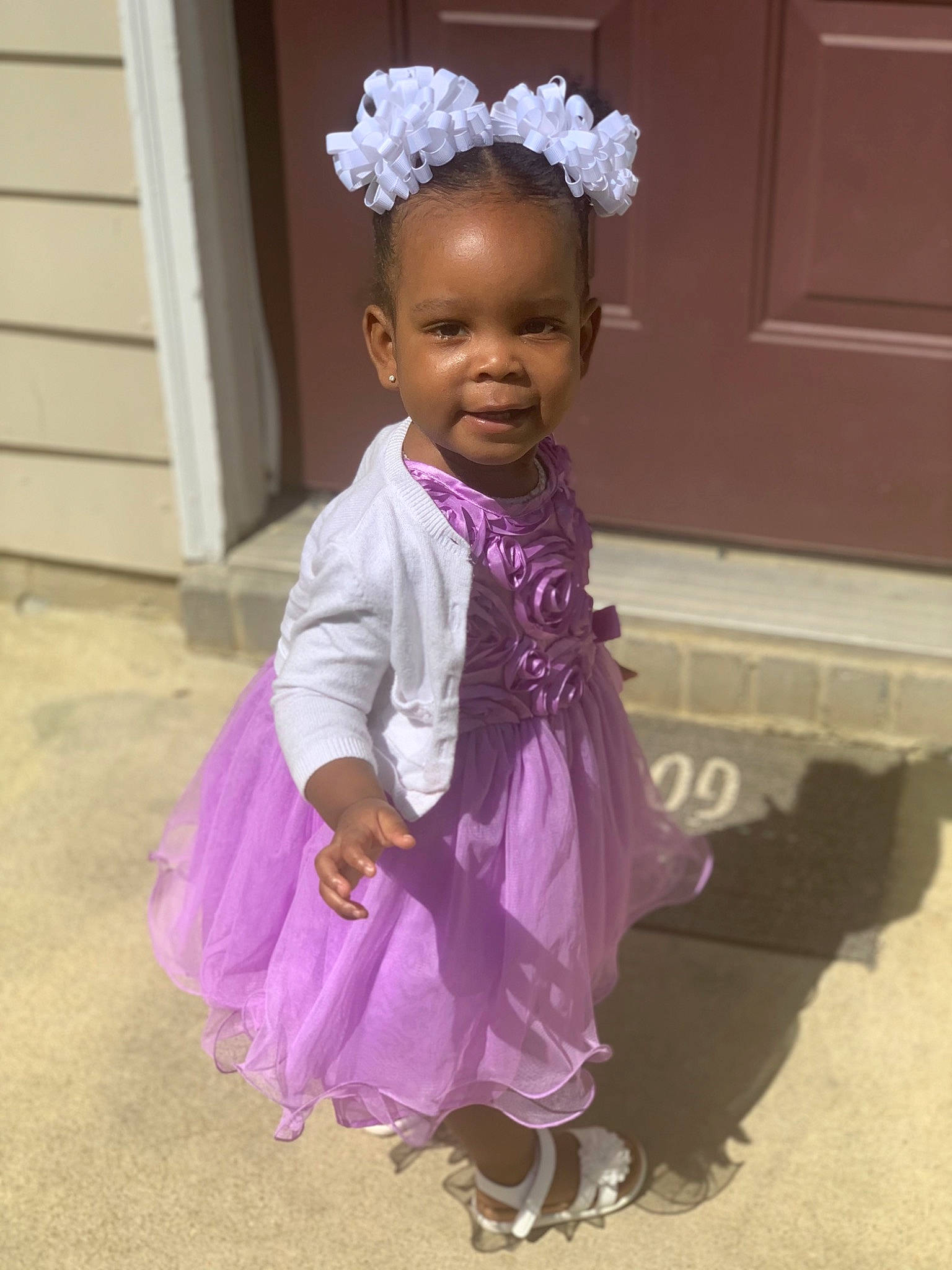 Katelynn is registered to the contest to win money with this photo: baby, baby_toddler_clothing, door, event, fashion_accessory, formal_wear, fun, hair_accessory, happy, headband, headgear, headpiece, magenta, person, pink, purple, sandal, sleeve, smile, toddler