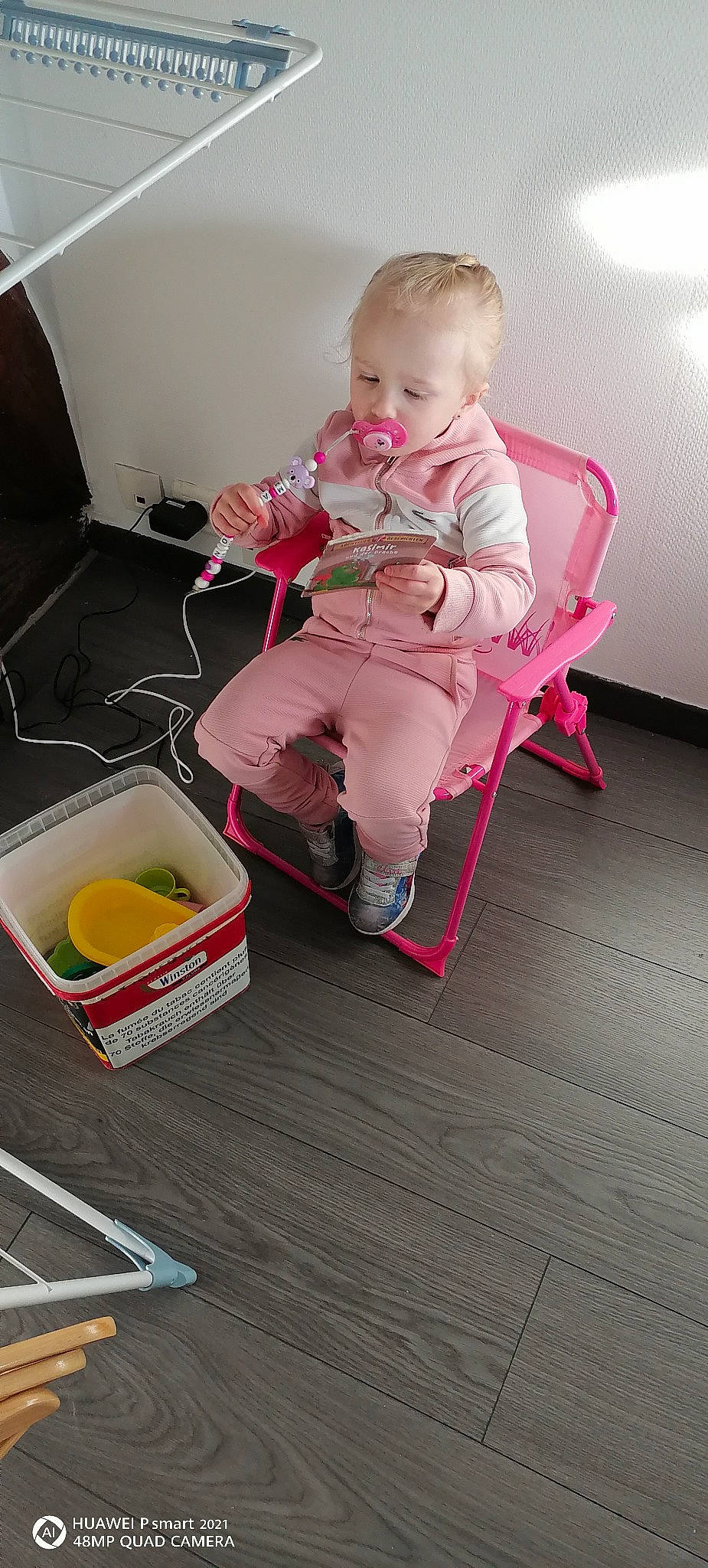Madison participe au concours pour gagner de l'argent avec cette photo : baby, baby_toddler_clothing, carmine, chair, child, comfort, floor, flooring, foot, hardwood, household_supply, human_leg, knee, magenta, person, pink, product, room, sitting, toddler