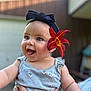baby, background_blur, blue_clothing, child, cute, eyes, flower, hand, happy, head, headband, holding, infant, mouth, nature, outdoor, person, portrait, skin, smiling
