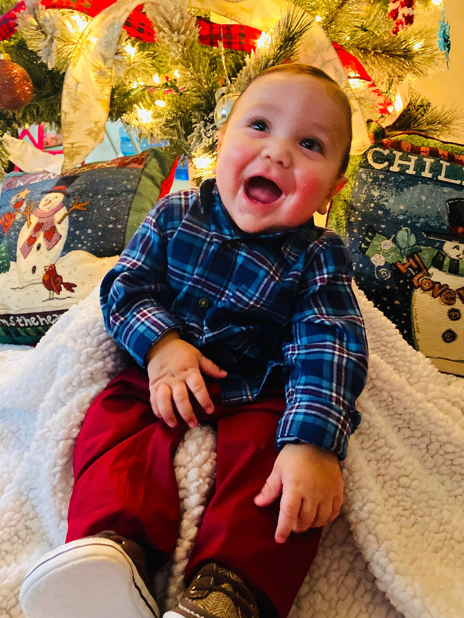 Anthony is registered to the contest to win money with this photo: baby_toddler_clothing, cheek, child, christmas_ornament, christmas_tree, eye, face, facial_expression, fun, happy, head, lap, organ, person, red, skin, smile, textile, toddler, tree