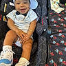 Darrian joined the competition — help win amazing prizes! baby, child, car_seat, smiling, cap, sneakers, bow_tie, gold_chain, striped_clothing, happy, infant, footwear, seated, cute, portrait, fashion, accessory, indoor, person, casual