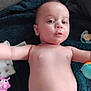 Loucas participe au concours pour gagner de l'argent avec cette photo : arm, baby, blanket, blue_toy, child, cute, diaper, expression, face, hand, indoor, infant, lying_down, pacifier, pink_toy, playful, skin, small, towel, toy