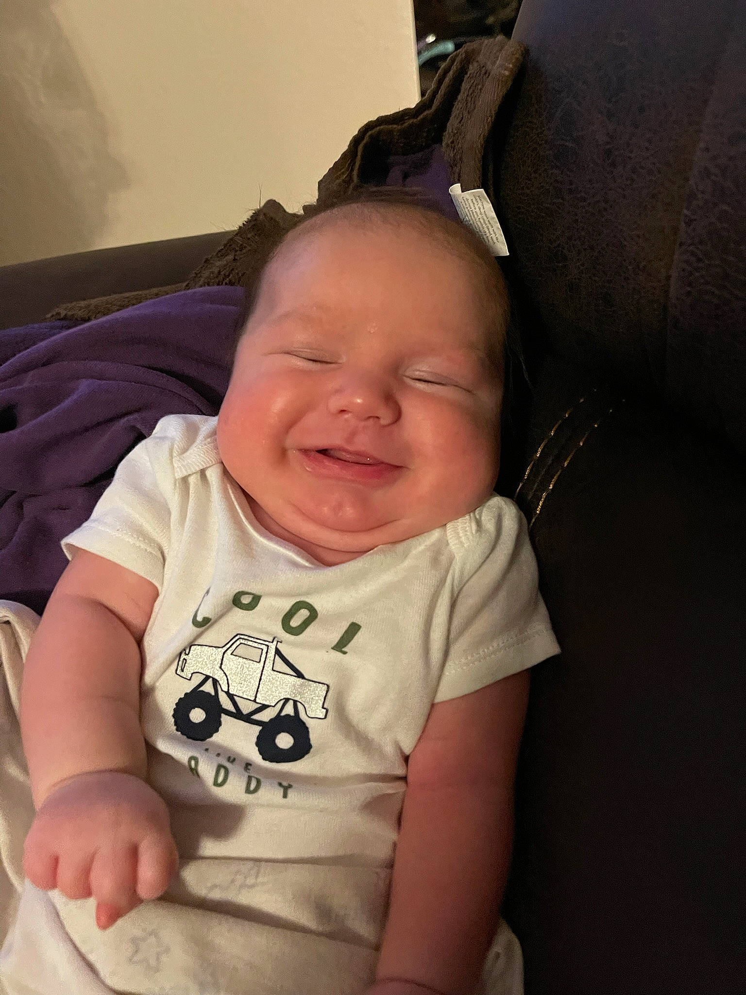 Sterling is registered to the contest to win money with this photo: baby, baby_toddler_clothing, cheek, chin, comfort, eyebrow, finger, happy, iris, lip, mouth, neck, nose, person, sitting, skin, sleeve, smile, t_shirt, thumb