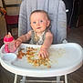 baby, high_chair, food, messy, sippy_cup, indoor, child, cute, blue_eyes, feeding, toddler, plate, floor, chair, table, person, meal, kitchen, hand, clothing