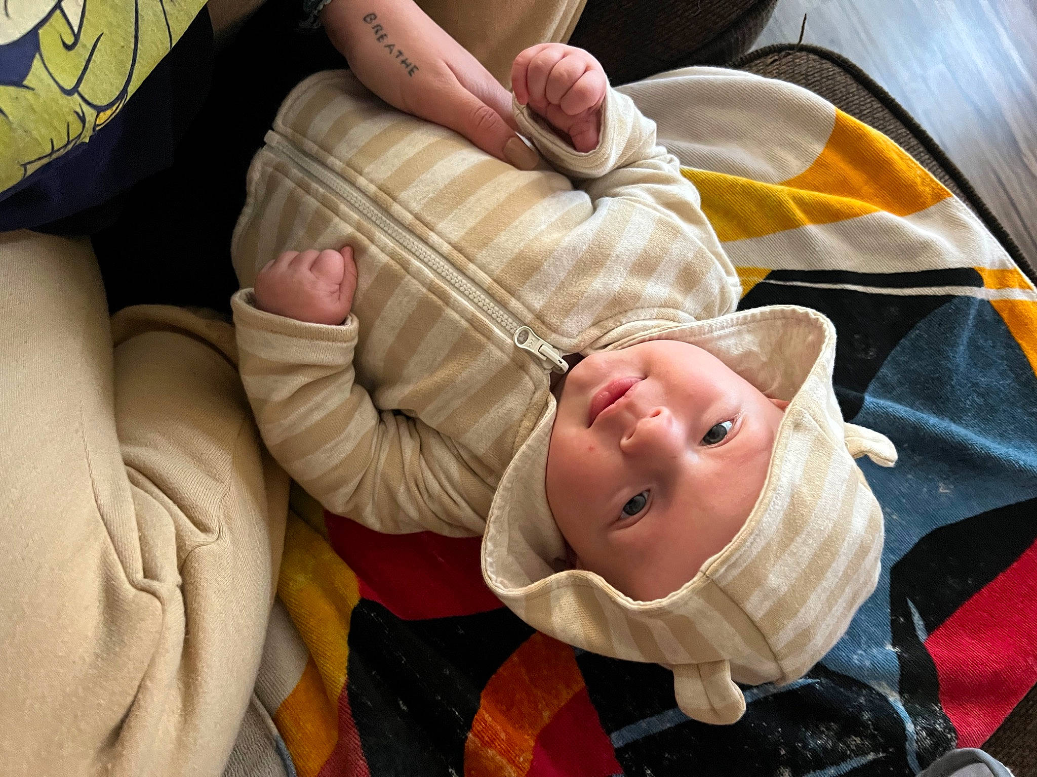 Gatlin is registered to the contest to win money with this photo: baby, baby_products, baby_safety, baby_toddler_clothing, cheek, child, comfort, fun, gesture, happy, hat, head, headgear, headwear, linens, person, room, sitting, sleeve, smile