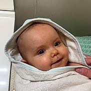 Capucine a rejoint le concours — aidez-le/la à gagner de superbes lots ! baby, towel, hood, smile, face, child, wrapped, soft, cute, infant, hand, indoor, blanket, cozy, person, portrait, skin, eyes, expression, newborn