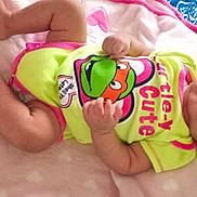 Marilyn joined the competition — help win amazing prizes! baby, infant, blanket, onesie, cartoon, turtle, cute, lying_down, soft_texture, pink, yellow, patterned_bedding, child, portrait, indoors, clothing, person, face, head, expression