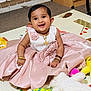 baby, child, dress, pink_dress, smile, happy, play_mat, plush_toy, stuffed_animal, yellow_duck, sitting, bracelet, necklace, indoor, carpet, floor, cute, portrait, young_child, person