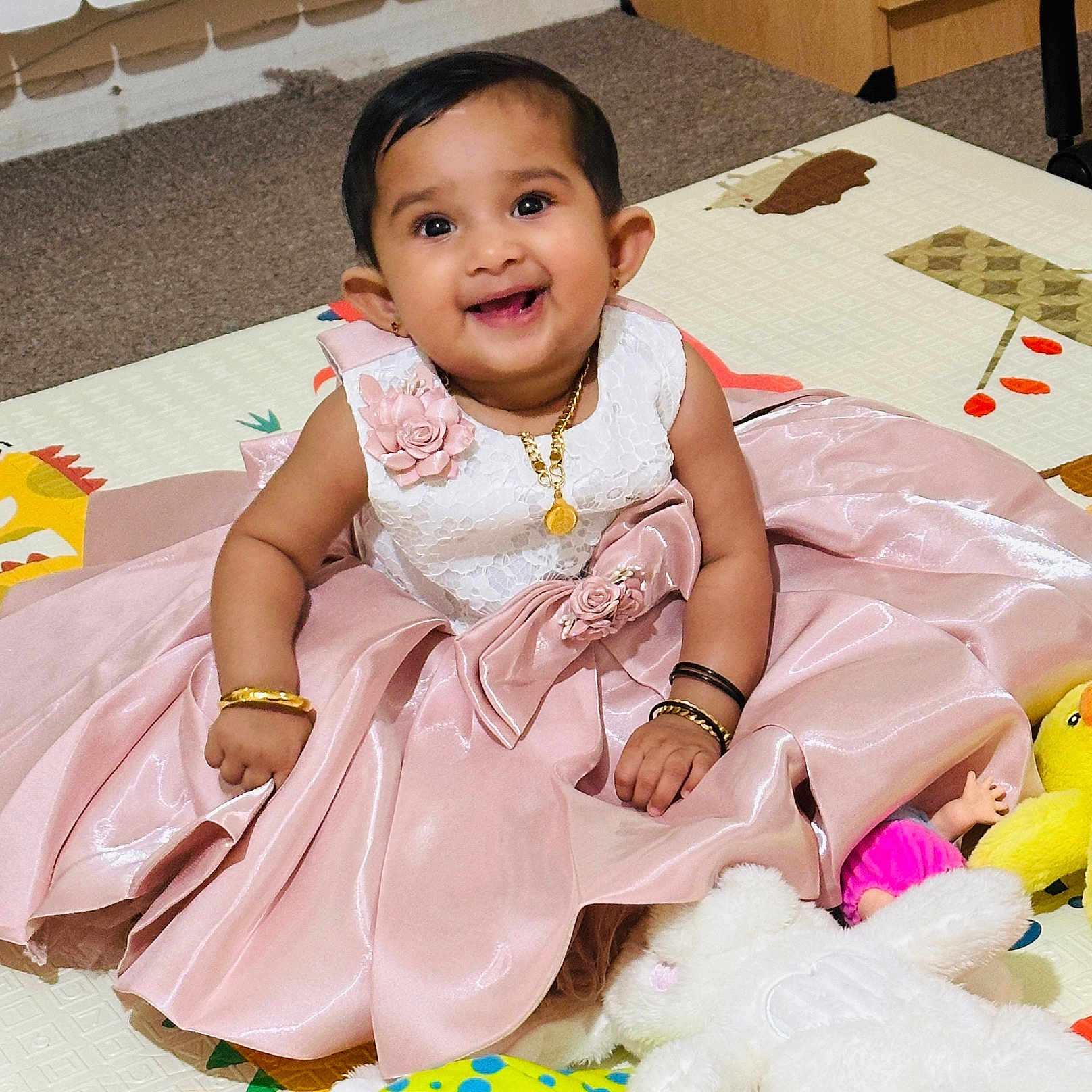 Deona joined the competition — help win amazing prizes! baby, bracelet, carpet, child, cute, dress, floor, happy, indoor, necklace, person, pink_dress, play_mat, plush_toy, portrait, sitting, smile, stuffed_animal, yellow_duck, young_child