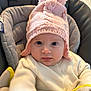 Margaux a rejoint le concours — aidez-le/la à gagner de superbes lots ! baby, blanket, car_seat, child, cozy, cute, indoor, infant, knit_hat, looking_at_camera, person, pink_hat, pom_pom, portrait, seated, soft_texture, warm_clothing, white_sweater, wide_eyes, young_child
