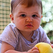 Marin participe au concours pour gagner de l'argent avec cette photo : baby, child, infant, face, eyes, cheeks, arm, hand, toy, yellow_ball, clothing, shirt, skin, portrait, closeup, indoor, soft_light, curious, lying_down, cute