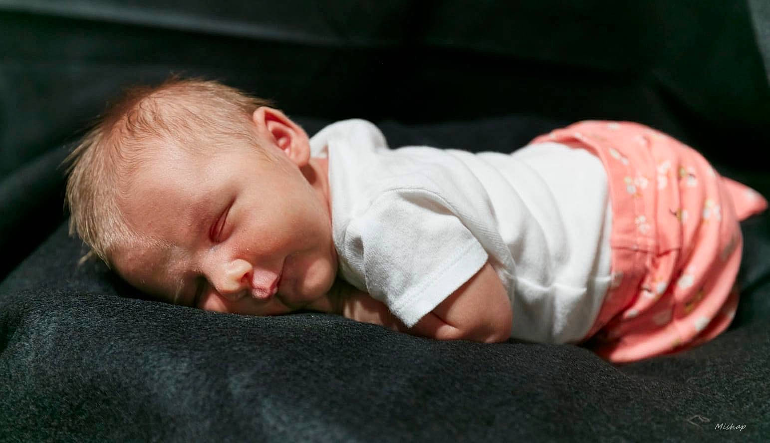 Scarlett is registered to the contest to win money with this photo: baby, baby_toddler_clothing, bedtime, cheek, child, chin, comfort, flash_photography, flooring, grass, head, nap, nose, person, portrait_photography, sitting, skin, sleep, sleeve, toddler