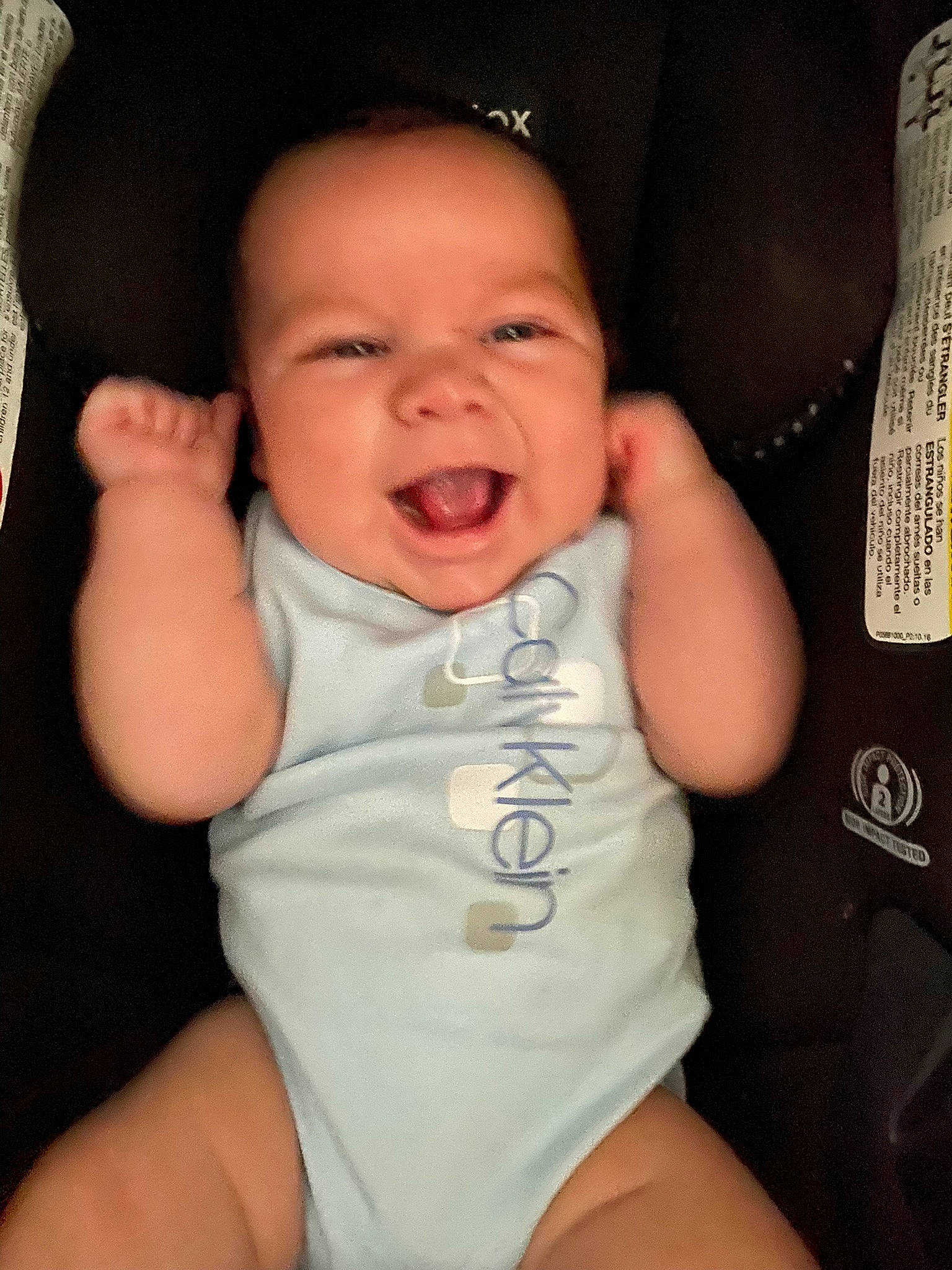 Gilbert is registered to the contest to win money with this photo: arm, baby, baby_toddler_clothing, cheek, comfort, eye, eyebrow, hand, head, lip, mouth, neck, nose, organ, person, product, skin, sleeve, smile, stomach