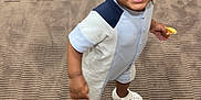 Jaouen a rejoint le concours — aidez-le/la à gagner de superbes lots ! baby, carpet, casual_clothing, child, cute, expression, food, footwear, hair, happy, holding, indoor, person, playful, romper, shorts, smiling, standing, toddler, young