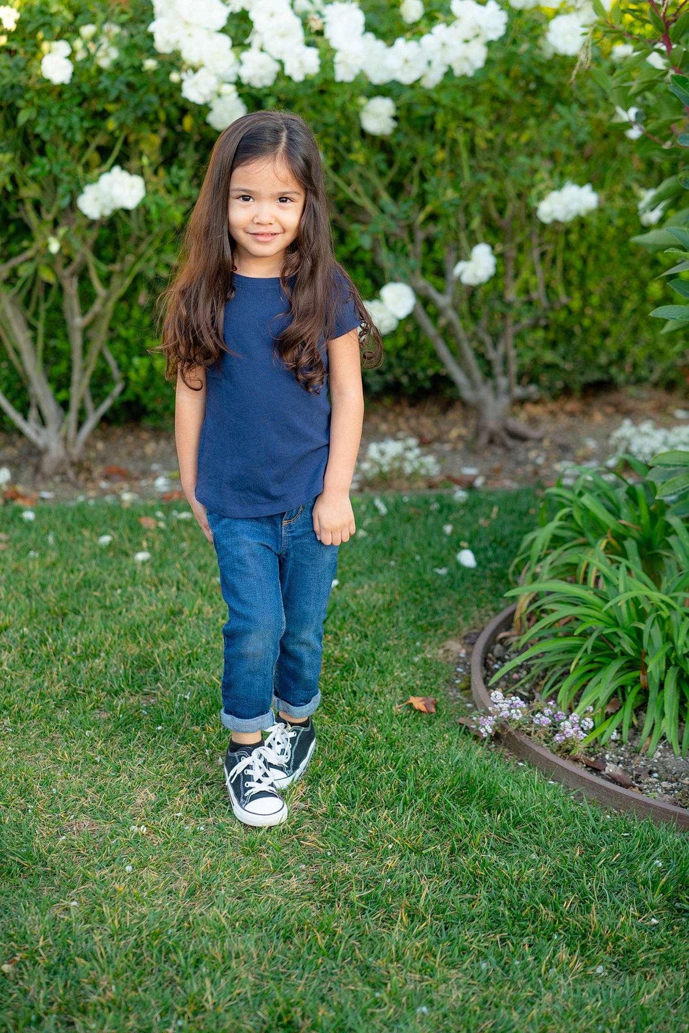 Mya Campos is registered to the contest to win money with this photo: botany, child, child_model, denim, footwear, garden, grass, grass_family, green, jeans, joy, lawn, long_hair, person, plant, shoe, smile, summer, t_shirt, textile