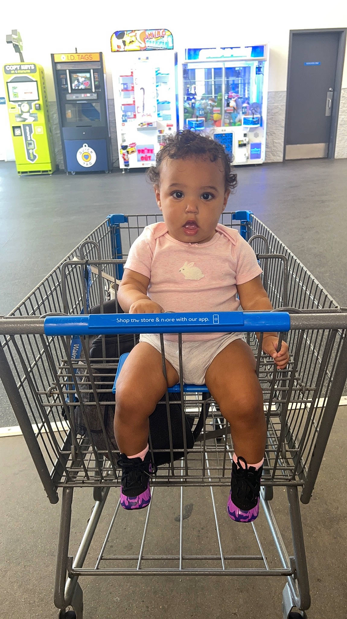Acelynn is registered to the contest to win money with this photo: baby_safety, baby_toddler_clothing, beauty, cart, child, cleanliness, electric_blue, fun, human_leg, knee, leisure, mammal, person, retail, shelf, shopping_cart, sitting, surprise, thigh, tire
