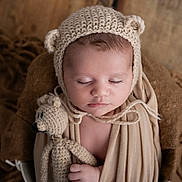Lenzo participe au concours pour gagner de l'argent avec cette photo : baby, sleeping, knitted_hat, bear_ears, crocheted_toy, teddy_bear, wrap, beige, brown, soft_texture, closeup, infant, peaceful, cute, portrait, child, cozy, hand, headwear, indoors