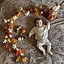 autumn, baby, blanket, brown, child, cozy_clothing, cream, cute, decor, fall, indoors, infant, leaves, lying_down, mushrooms, pinecones, pumpkins, seasonal, smiling, soft_texture