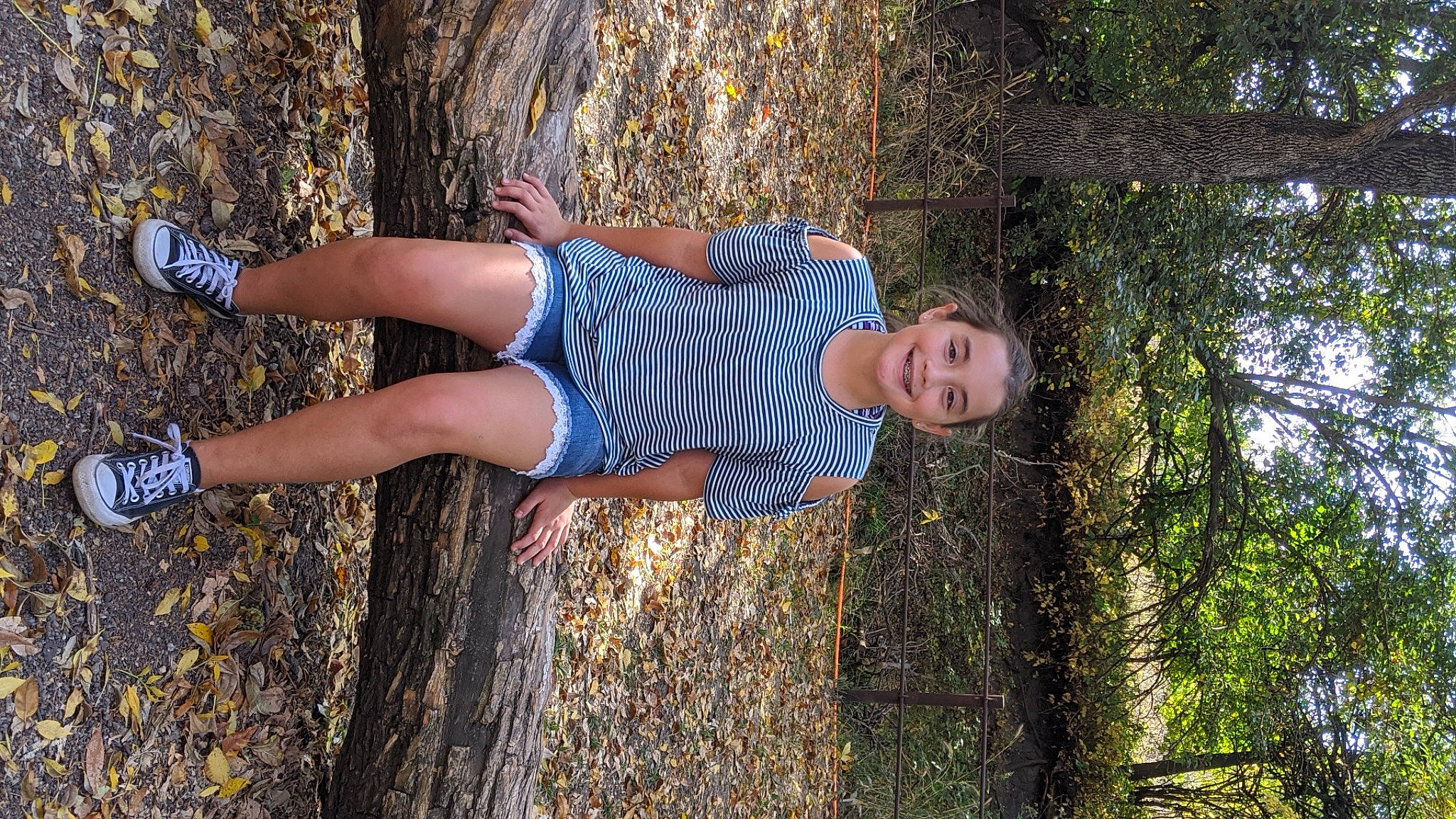 Kayli is registered to the contest to win money with this photo: arm, calf, denim, flash_photography, grass, hand, happy, human_body, human_leg, joy, knee, leisure, people_in_nature, person, plant, street_fashion, sunlight, thigh, tree, trunk