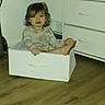 Marianna is registered to the contest to win money with this photo: toddler, child, drawer, dresser, furniture, indoor, portrait, sitting, smiling, face, brown_hair, long_sleeves, pajamas, barefoot, wood_floor, home, bedroom, storage, playful, photograph