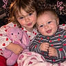 children, siblings, toddler, baby, portrait, smiling, cuddling, stuffed_animal, bunny, pink, hearts, blanket, cozy, indoor, bed, close_up, blue_eyes, brown_hair, happy, family