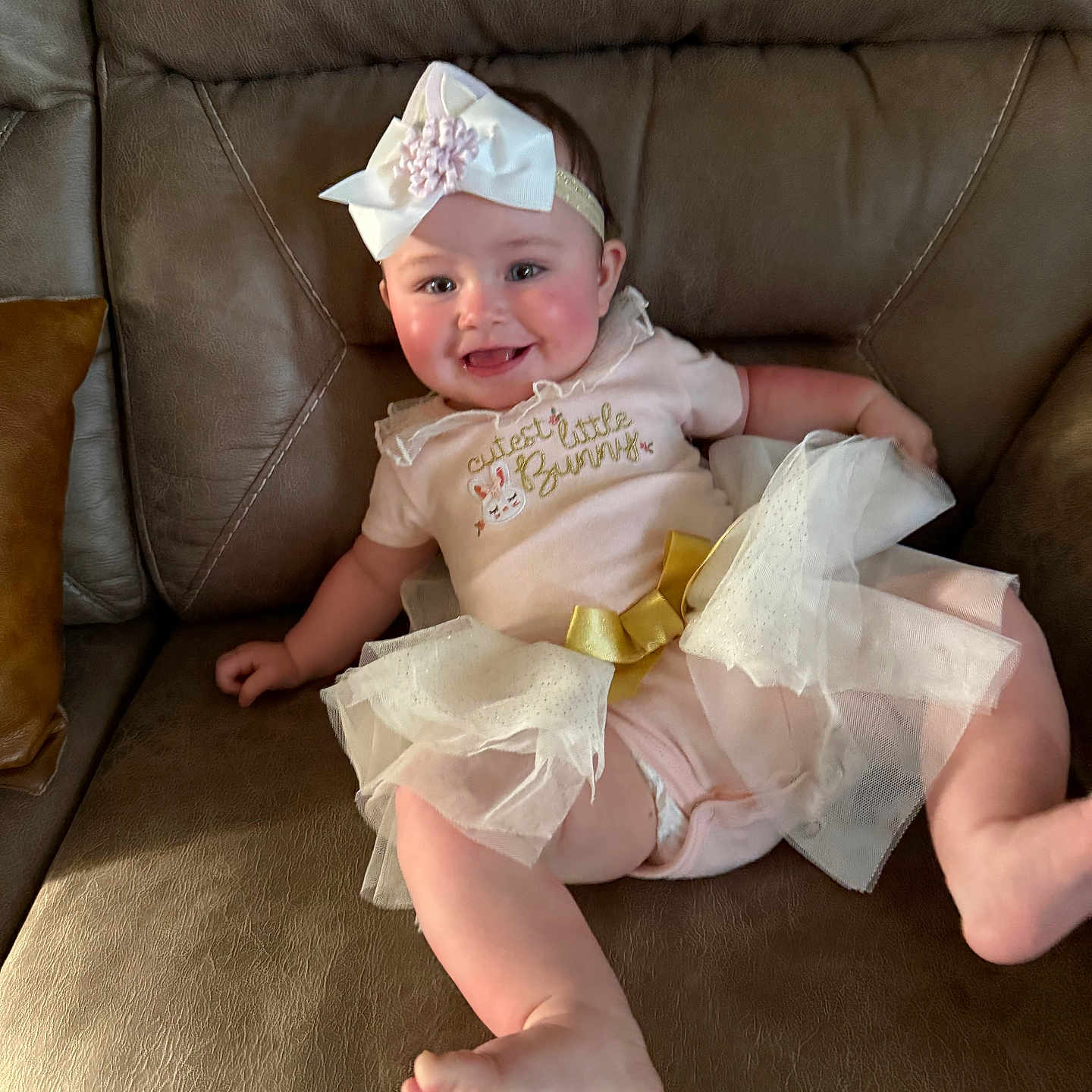 Kenzie joined the competition — help win amazing prizes! accessories, baby, bodypart, bonnet, clothing, couch, diaper, dress, face, finger, formalwear, furniture, hand, hat, head, jewelry, person, photography, portrait, sitting